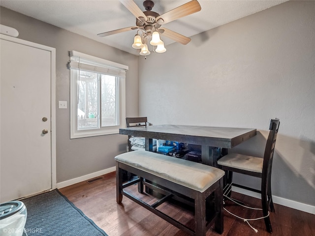 dining area with hardwood / wood-style floors and ceiling fan