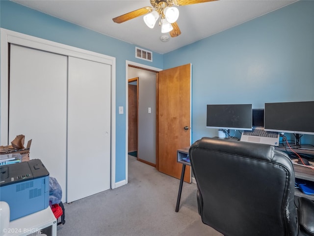 carpeted home office with ceiling fan