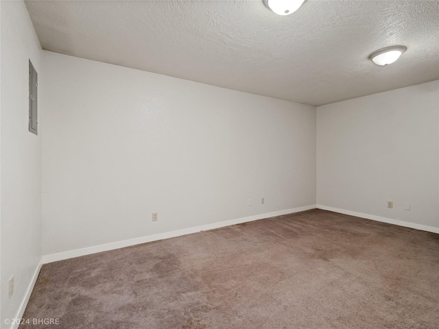 carpeted spare room featuring a textured ceiling