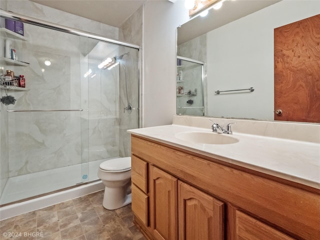 bathroom featuring vanity, toilet, and walk in shower