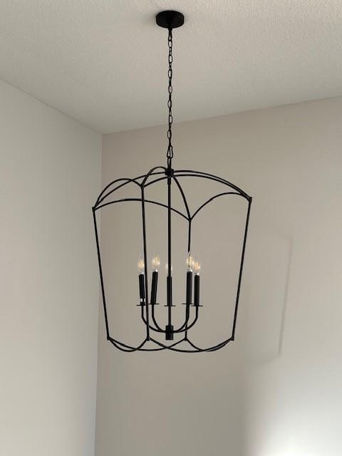 703 Richland Ct, Van Meter, IA 50261 - interior details featuring a chandelier