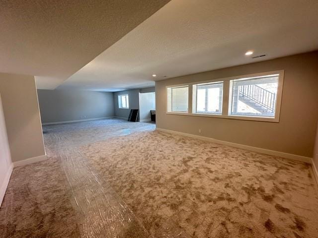 bonus room with carpet floors, recessed lighting, a textured ceiling, and baseboards