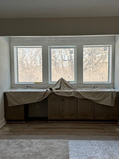 interior details featuring baseboards and wood finished floors