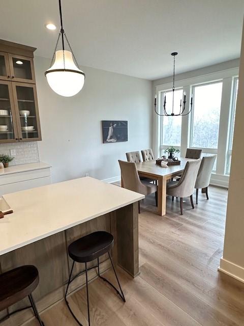 703 Richland Ct, Van Meter, IA 50261 - dining room with recessed lighting, an inviting chandelier, light wood-style flooring, and baseboards