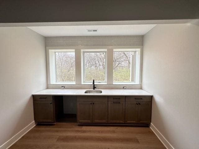 703 Richland Ct, Van Meter, IA 50261 - interior space with a sink, visible vents, light wood-style floors, and baseboards