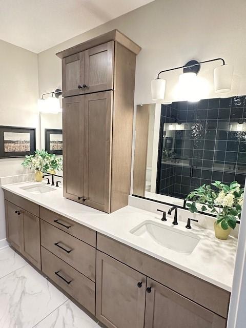 703 Richland Ct, Van Meter, IA 50261 - full bath featuring double vanity, a tile shower, marble finish floor, and a sink