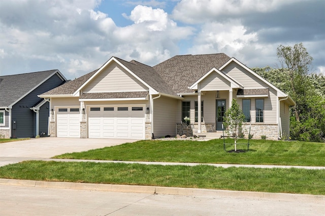703 Richland Ct, Van Meter, IA 50261 - craftsman-style house with stone siding, a garage, driveway, a front yard, and roof with shingles