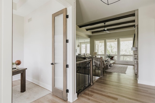 703 Richland Ct, Van Meter, IA 50261 - hall with wood finished floors, an upstairs landing, and beamed ceiling