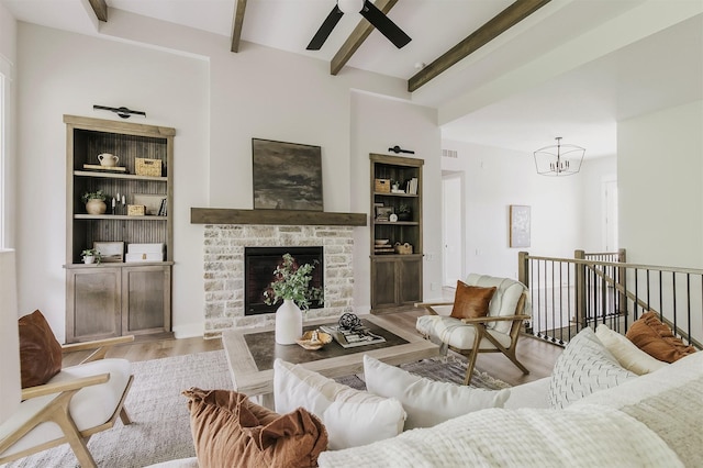 703 Richland Ct, Van Meter, IA 50261 - living area with beamed ceiling, wood finished floors, ceiling fan, a chandelier, and a fireplace