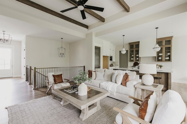 703 Richland Ct, Van Meter, IA 50261 - living room with a chandelier, light wood-type flooring, beam ceiling, and a ceiling fan