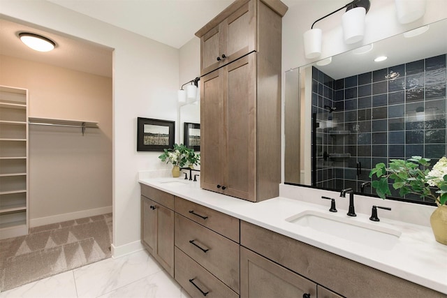 703 Richland Ct, Van Meter, IA 50261 - full bathroom with double vanity, a tile shower, and a walk in closet