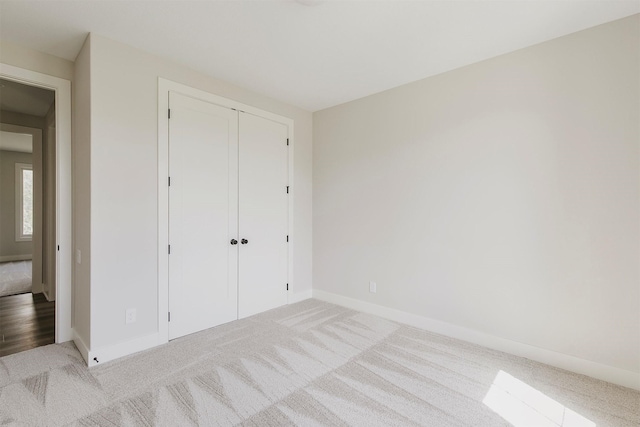 703 Richland Ct, Van Meter, IA 50261 - unfurnished bedroom featuring carpet floors and a closet