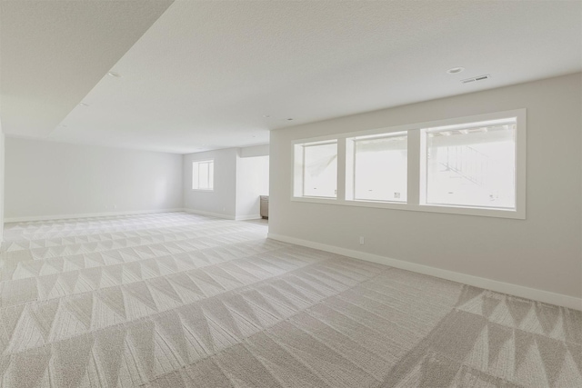 703 Richland Ct, Van Meter, IA 50261 - spare room featuring light carpet and baseboards