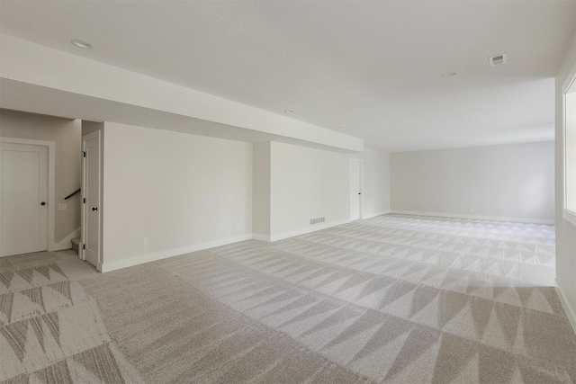 703 Richland Ct, Van Meter, IA 50261 - finished basement featuring light carpet and stairway