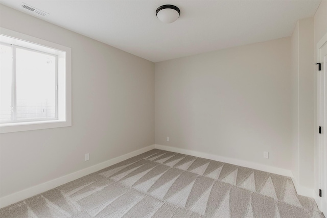 703 Richland Ct, Van Meter, IA 50261 - spare room featuring light carpet and baseboards