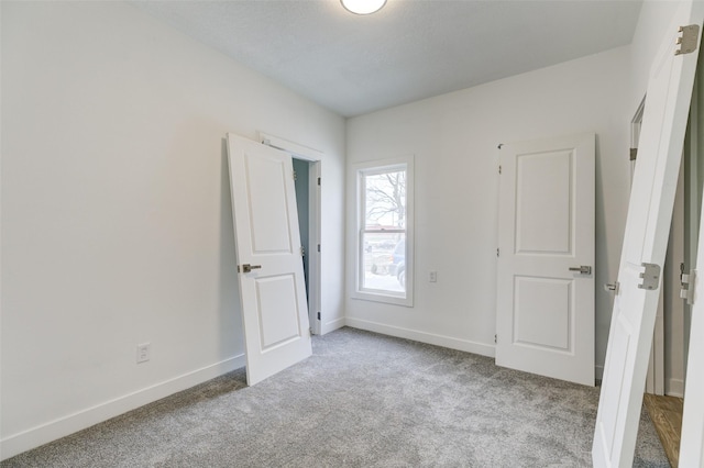 unfurnished bedroom featuring light carpet