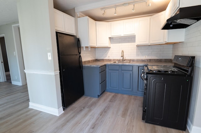 kitchen with backsplash, black appliances, sink, light hardwood / wood-style floors, and white cabinetry