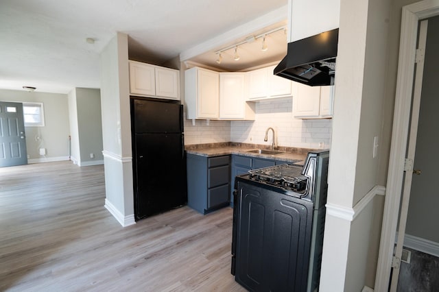 kitchen with white cabinetry, sink, light hardwood / wood-style flooring, decorative backsplash, and black appliances