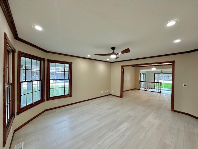 unfurnished room featuring ceiling fan, crown molding, and light hardwood / wood-style floors