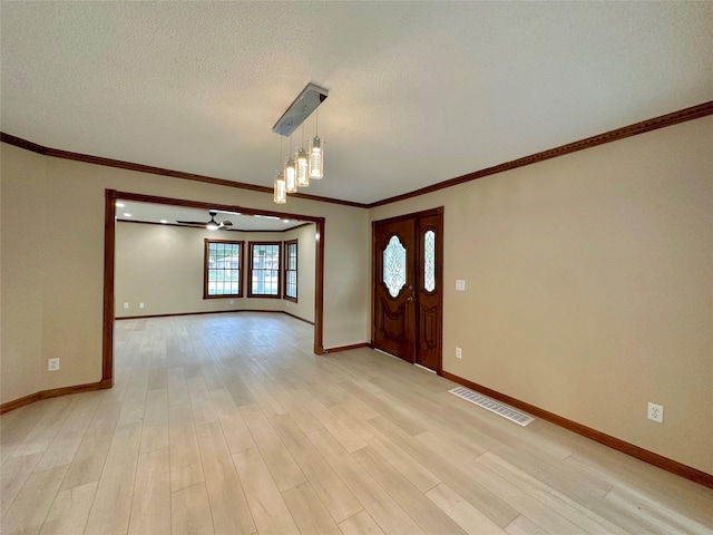 foyer with a textured ceiling, light wood-type flooring, ceiling fan, and ornamental molding