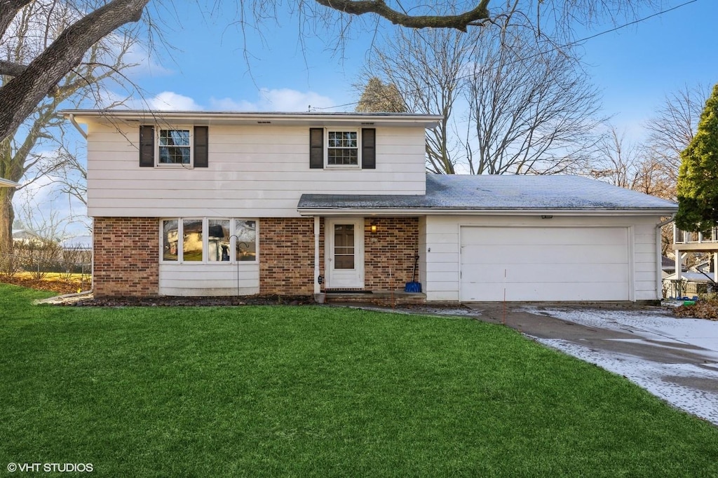 view of front property with a front yard and a garage