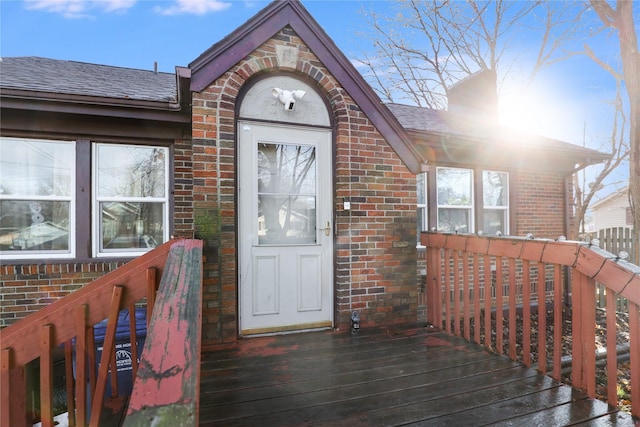 view of exterior entry with a deck