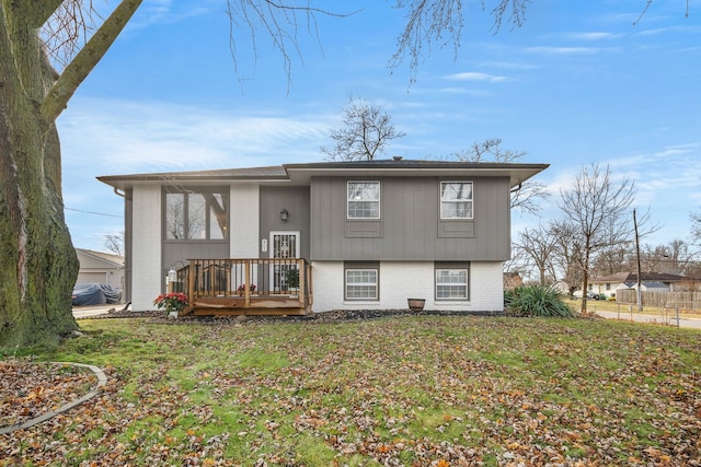 rear view of property featuring a yard