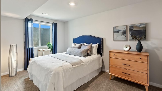 bedroom featuring carpet floors, visible vents, and baseboards