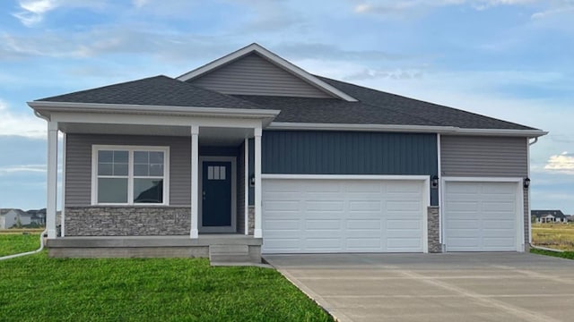 view of front facade with stone siding, roof with shingles, an attached garage, and concrete driveway