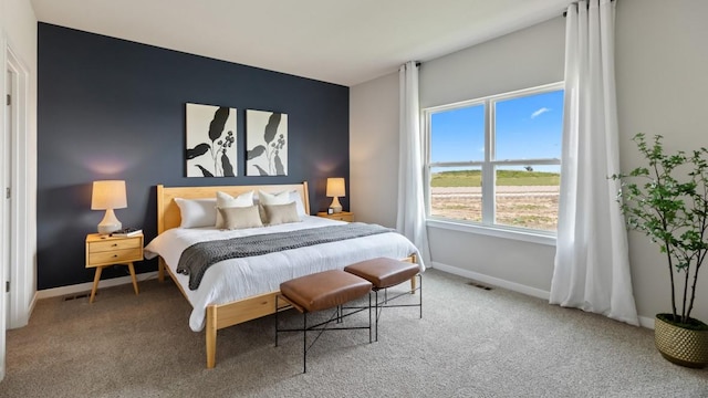 bedroom with carpet floors, baseboards, and visible vents