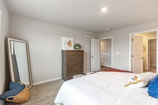 carpeted bedroom with visible vents and baseboards