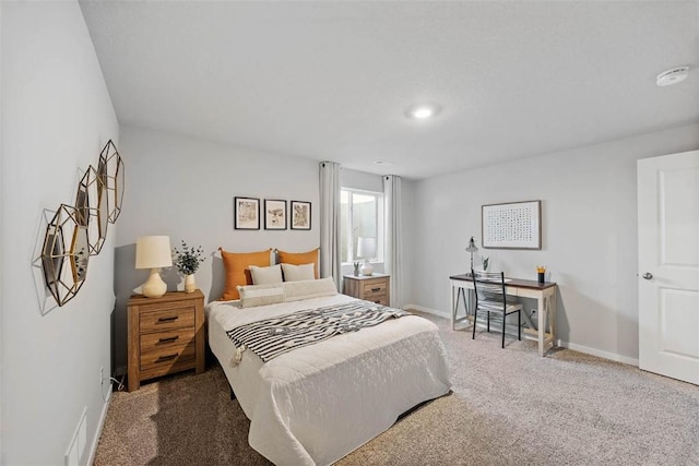 bedroom featuring visible vents, baseboards, and carpet