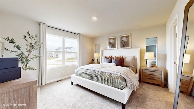 bedroom featuring light colored carpet