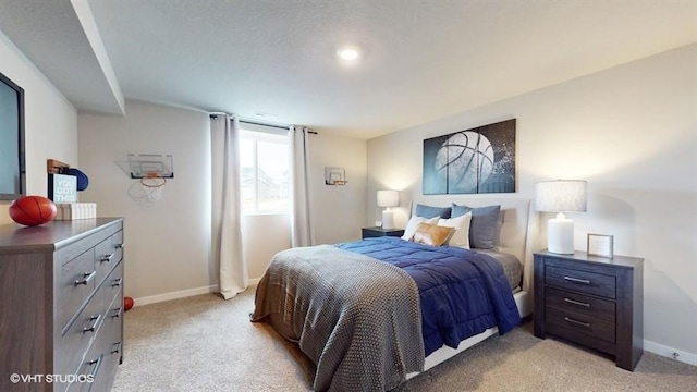 bedroom featuring light carpet and baseboards