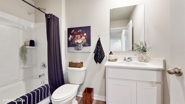 full bathroom with hardwood / wood-style flooring, vanity, shower / bath combination with curtain, and toilet