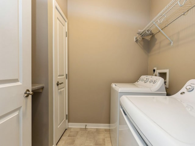 clothes washing area with washing machine and clothes dryer