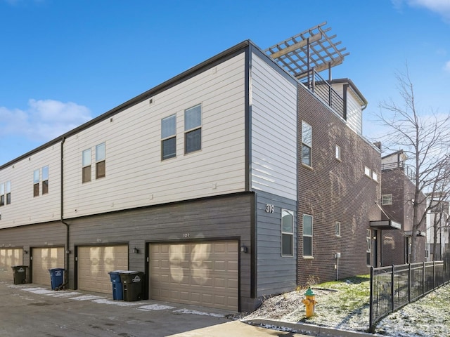 back of house featuring a garage