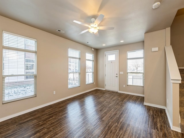 foyer entrance featuring dark hardwood / wood-style floors, plenty of natural light, and ceiling fan