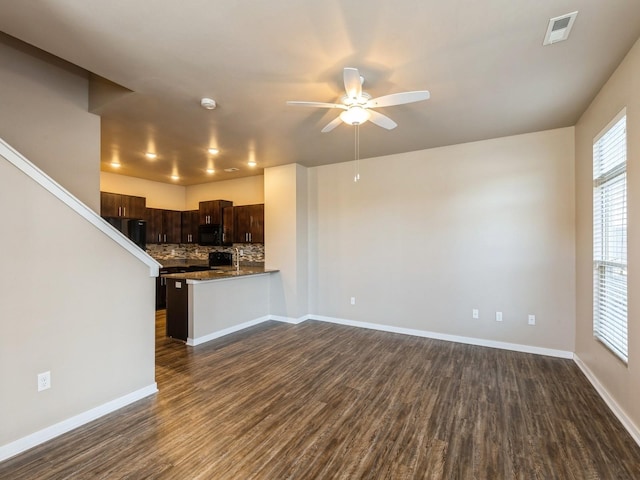 319 SW 7th St Unit 107, Des Moines, IA 50309 - kitchen with black microwave, stove, dark wood-type flooring, and ceiling fan