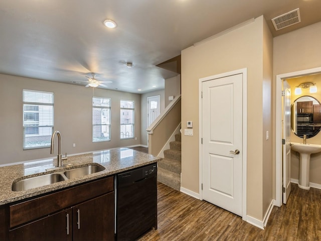 319 SW 7th St Unit 107, Des Moines, IA 50309 - kitchen with black appliances, dark wood-style flooring, dark brown cabinets, ceiling fan, and light stone countertops