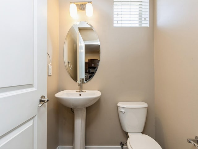 bathroom featuring toilet and sink