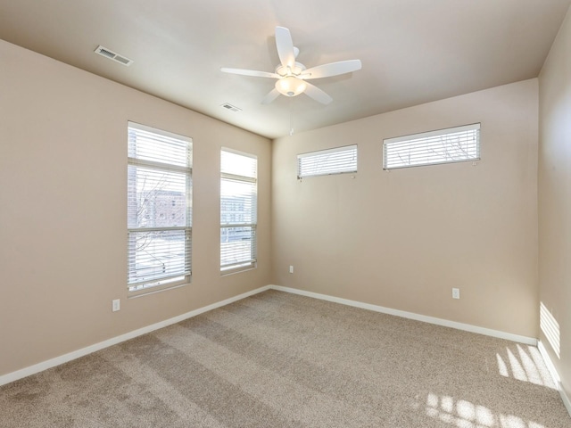 carpeted empty room featuring ceiling fan