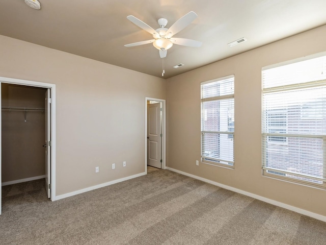 unfurnished bedroom with ceiling fan, a closet, and carpet