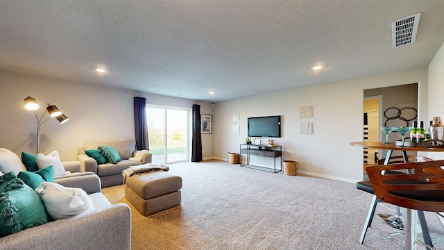 living room featuring a textured ceiling and light carpet