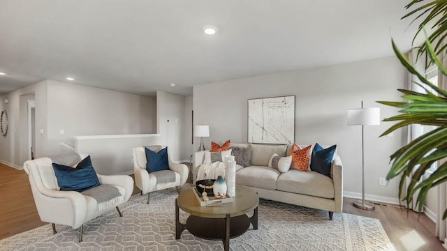 living room with recessed lighting, baseboards, and wood finished floors