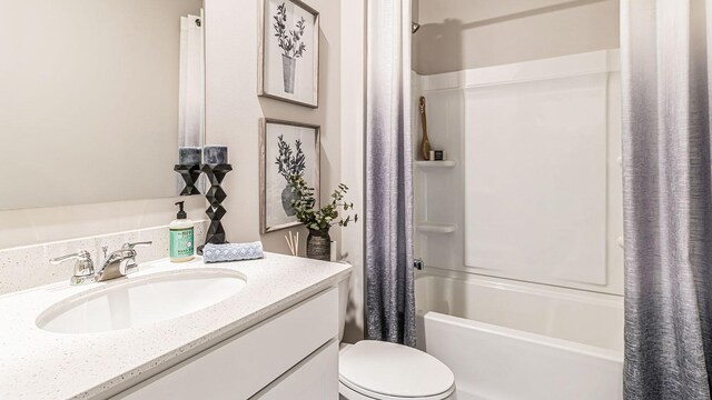 full bathroom with vanity, shower / tub combo, and toilet