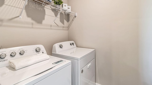 laundry room featuring washing machine and clothes dryer