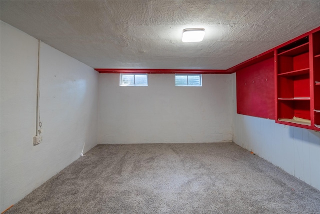 basement with carpet and a textured ceiling