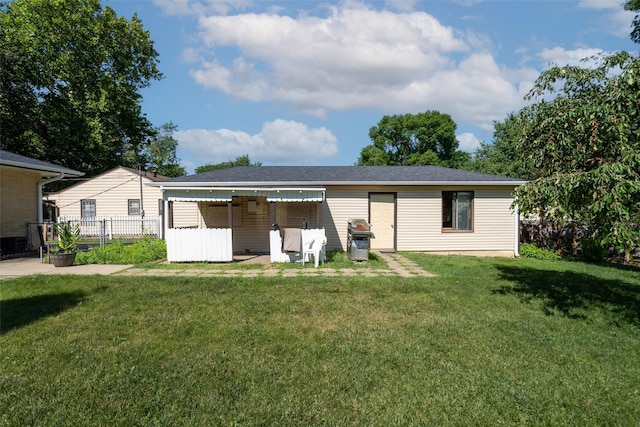 rear view of house with a lawn