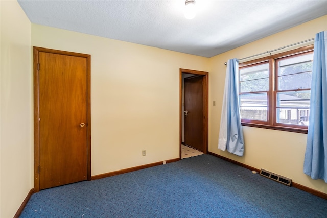 unfurnished room featuring carpet flooring